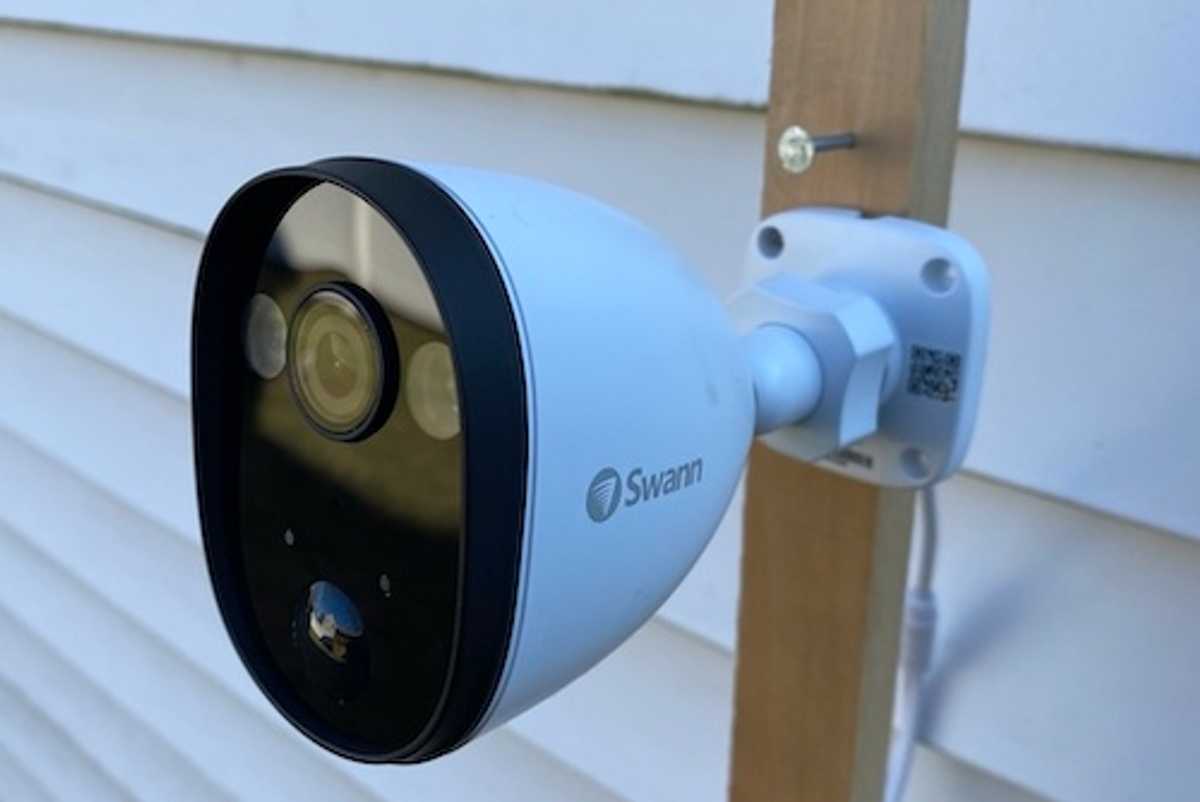 Swann Spotlight Outdoor Security Camera mounted outside a home.