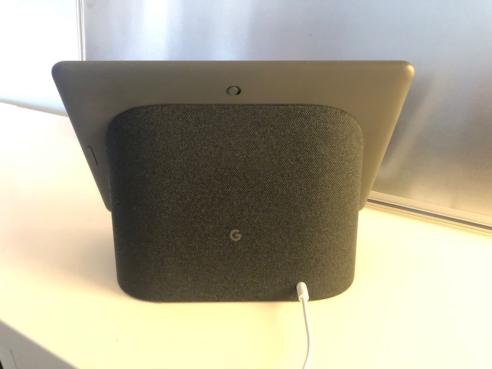 The back of the Nest Hub Max with dark gray fabric on a white counter