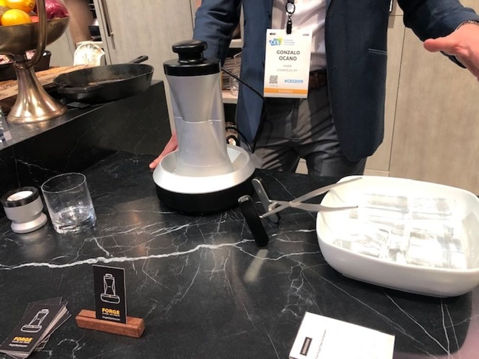 The Forge Clear Ice System in silver on a black marbled table