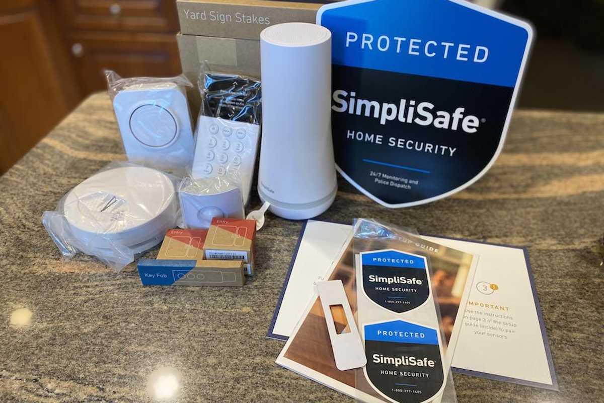 The SimpliSafe Hearth Home Security System unboxed on a counter.