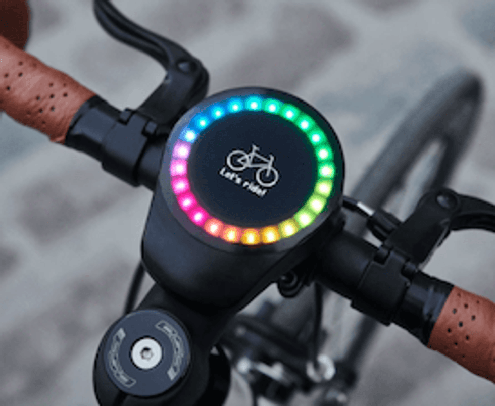 The SmartHalo2 on a bike showing a rainbow of light on its round display