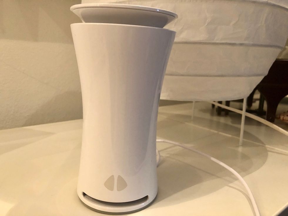 The uHoo air sensor on a white table