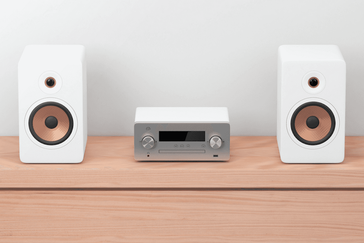 Two speakers next to a tuner