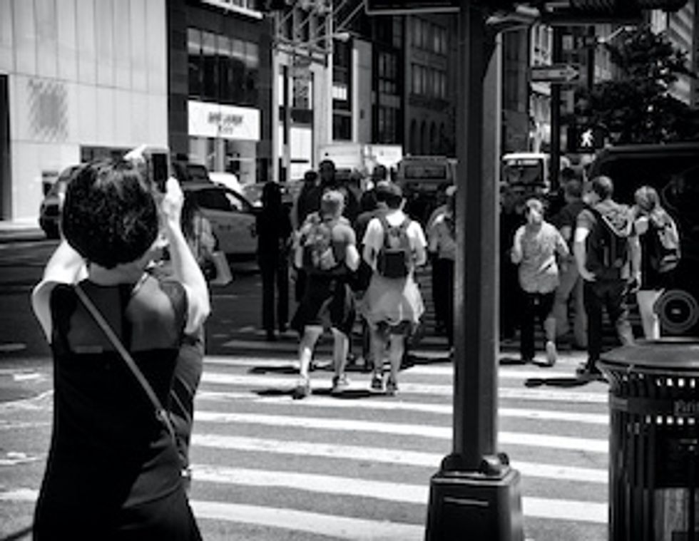 Woman taking smartphone photos, 5th Ave, Midtown Manhattan, NYC