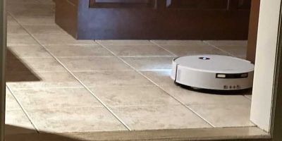 photo of Yeedi M16 Infinity vacuuming the floor with lights on
